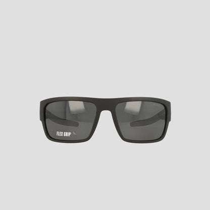 A pair of Champion Men's Polarized Grilamid Flex Grip Tip - Large sunglasses, featuring a black rectangular frame with dark lenses, is displayed against a light gray background. The left lens displays the white "FLEX GRIP" text. Designed for ultra-lightweight comfort, these sunglasses also offer an RX-able frame for added versatility.