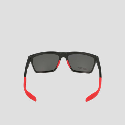 Men's Polarized Grilamid Flex Grip Tip - Medium sunglasses by Champion, shown from the back. Featuring a sleek black frame with rectangular dark lenses, these shades stand out with bright red temple tips and accents along the arms for a bold contrast. Crafted from lightweight TR90 Grilamid, this RX-able frame is designed for comfortable everyday wear. Set against a plain light gray background.
