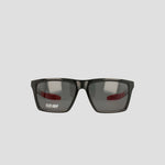 Black sunglasses with rectangular, polarized lenses and a slight reflection, featuring the text FLEX GRIP on the left lens. The lightweight, RX-able TR90 Grilamid frame from Champion's Men's Polarized Grilamid Flex Grip Tip - Medium is positioned against a plain light gray background.