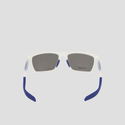 A pair of Champion Men's Polarized Grilamid Flex Grip Tip sunglasses in medium size, featuring rectangular translucent white RX-able TR90 frames with dark lenses and blue-tipped arms, is shown from the back against a plain light gray background.