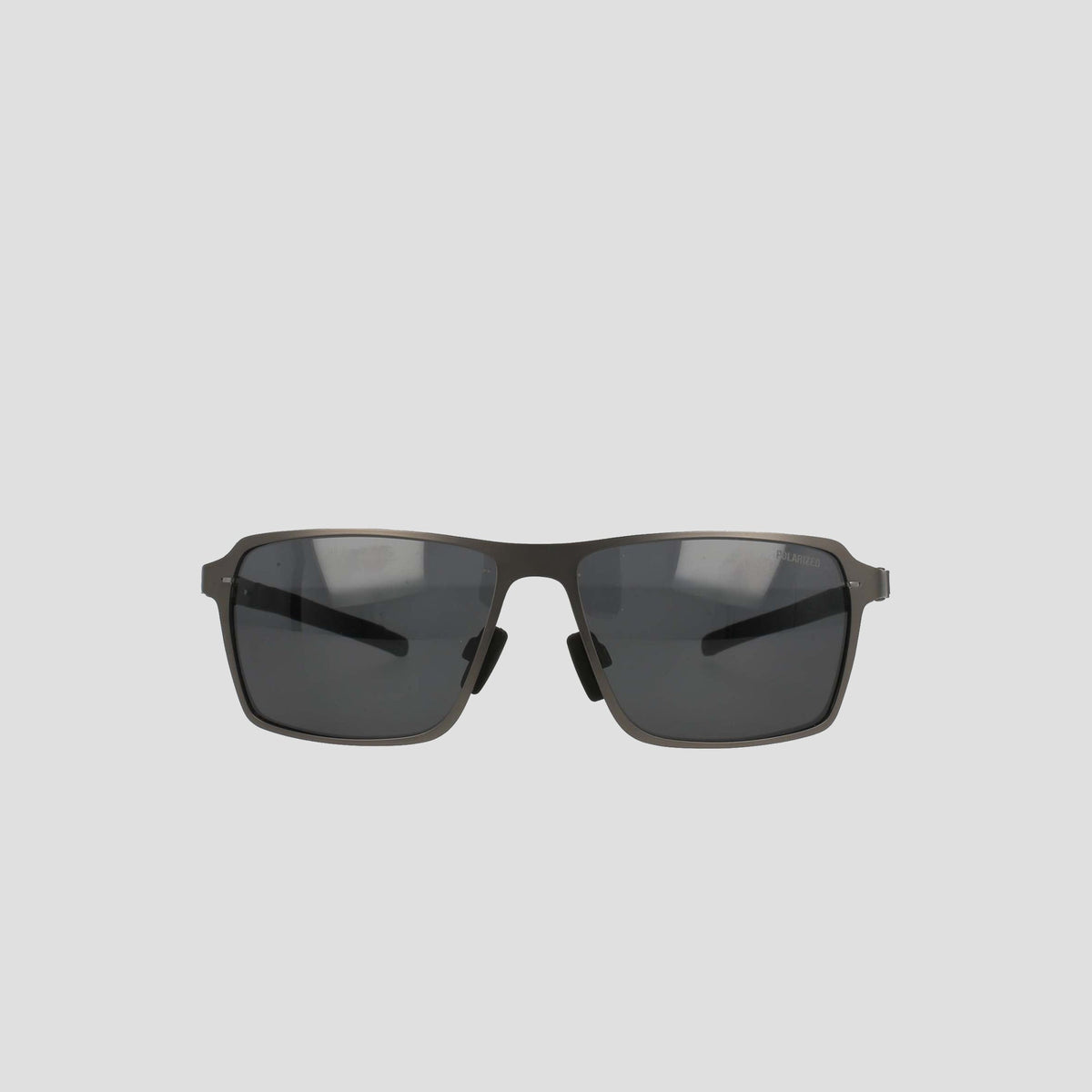 The Champion Men's Polarized Stainless ST-Shirtl Comfort Fit sunglasses feature a rectangular design, dark lenses, and a lightweight stainless steel frame with thin adjustable rubber tips, displayed on a plain light gray background.