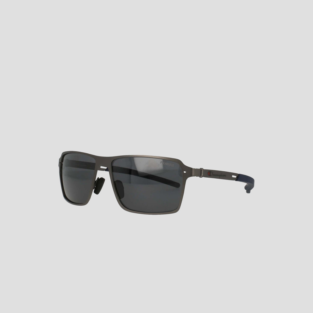 Champion Men's Polarized ST-Shirtl Comfort Fit sunglasses feature a sleek rectangular black design with thin stainless steel arms, adjustable rubber tips, and polarized lenses, set against a plain light gray background.
