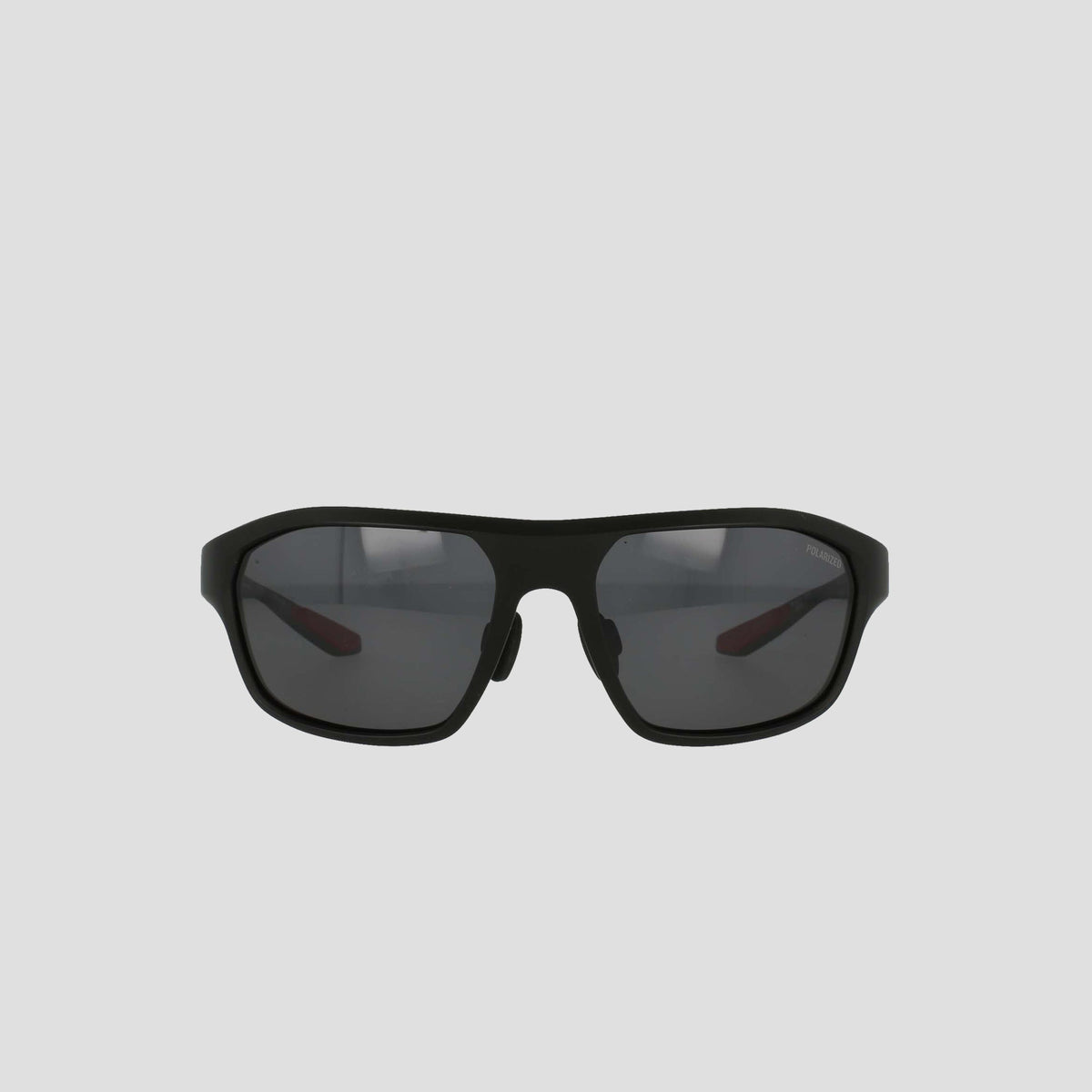 Champion Men's Polarized Comfort Fit - Large sports sunglasses, featuring a black, slightly curved TR90 frame with polarized lenses. The design includes adjustable rubber tips for enhanced comfort and a secure fit, displayed against a plain, light gray background.