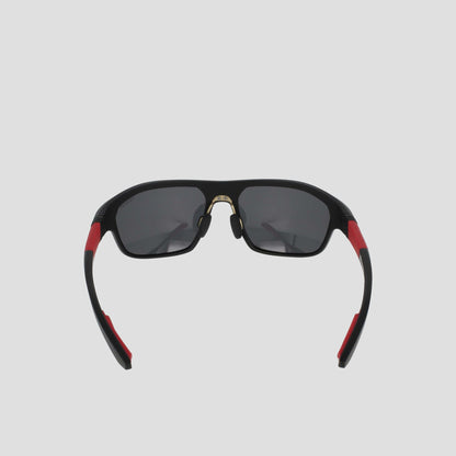 Champion Men's Polarized Comfort Fit - Large sunglasses with black, polarized dark lenses, accented by red details on the TR90 frame arms and a gold nose bridge, plus adjustable rubber tips, shown against a plain light gray background.