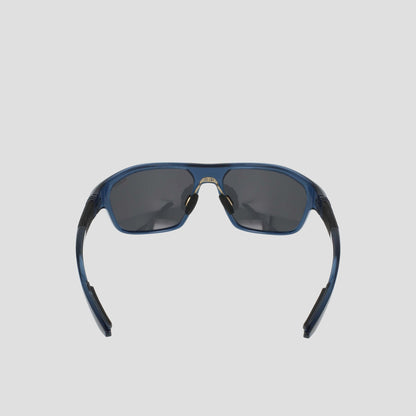 A pair of Champion Men's Polarized Comfort Fit - Large sports sunglasses are shown from the front against a light gray background. The blue TR90 frame offers lightweight durability, while the arms are slightly open and feature black detailing. The dark polarized lenses complete the look.