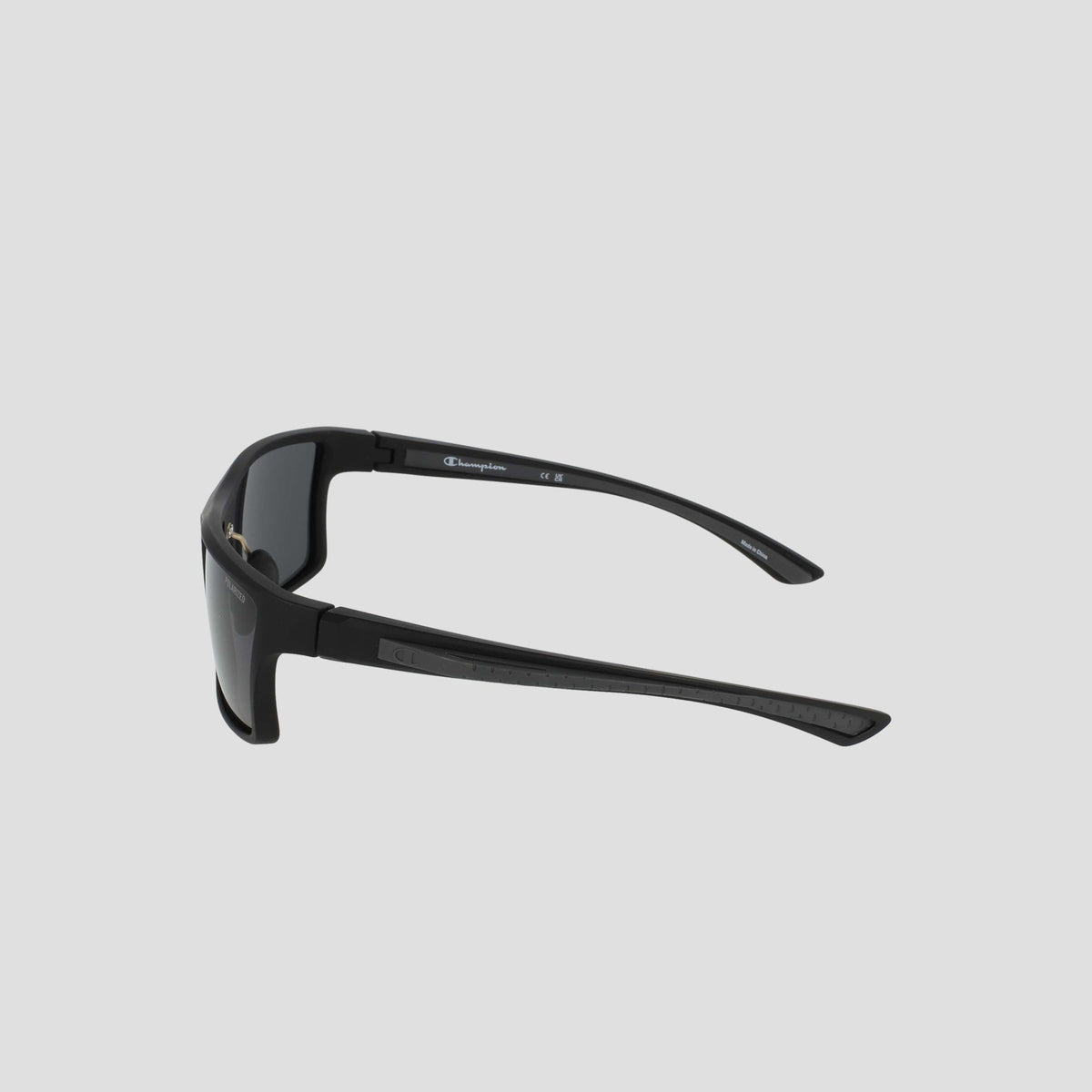 Men's Polarized Comfort Fit - Medium by Champion, featuring black wraparound frames with thick arms and a lightweight design, displayed from a rear side angle against a plain light gray background.