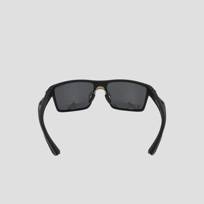 Men's Polarized Comfort Fit - Medium sunglasses by Champion, shown from the front against a light gray background. Featuring a lightweight black rectangular frame with dark lenses, the partially folded arms and visible nose pads highlight their comfortable design.