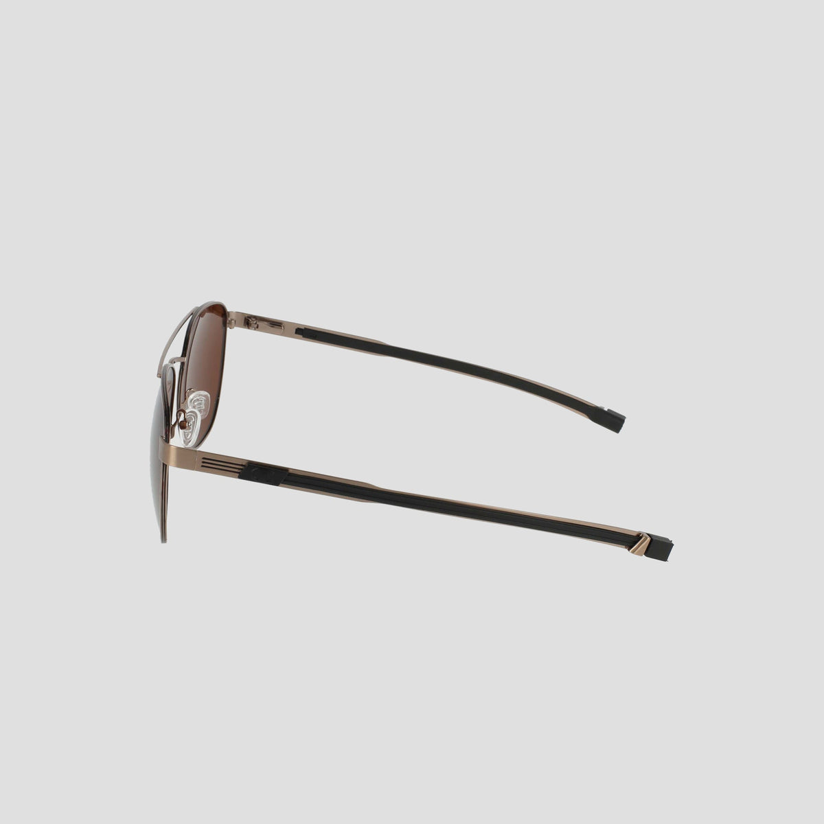 Side view of the Champion Men’s Polarized Retainer Stainless ST-Shirtl Aviator sunglasses, featuring slim gold stainless steel frames and black earpieces, set against a plain light grey background.