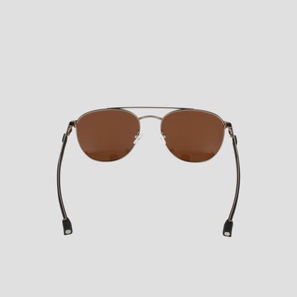 The Champion Men’s Polarized Retainer Stainless ST-Shirtl Aviator sunglasses are shown on a light gray background, featuring brown polarized lenses and a slim, lightweight stainless steel frame with straight arms finished in black plastic tips.