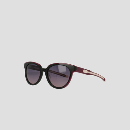 The Champion Women's Polarized Retainer Round sunglasses feature black and dark purple frames with gradient tinted lenses, perfect for women's fashion, displayed on a plain light gray background.