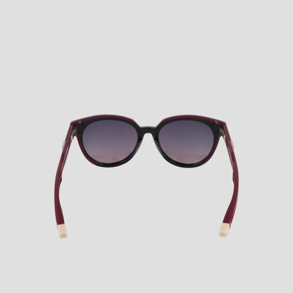 The Champion Women's Polarized Retainer Round eyewear features dark round lenses, a black front frame, and maroon arms with beige tips, displayed on a plain light gray background.