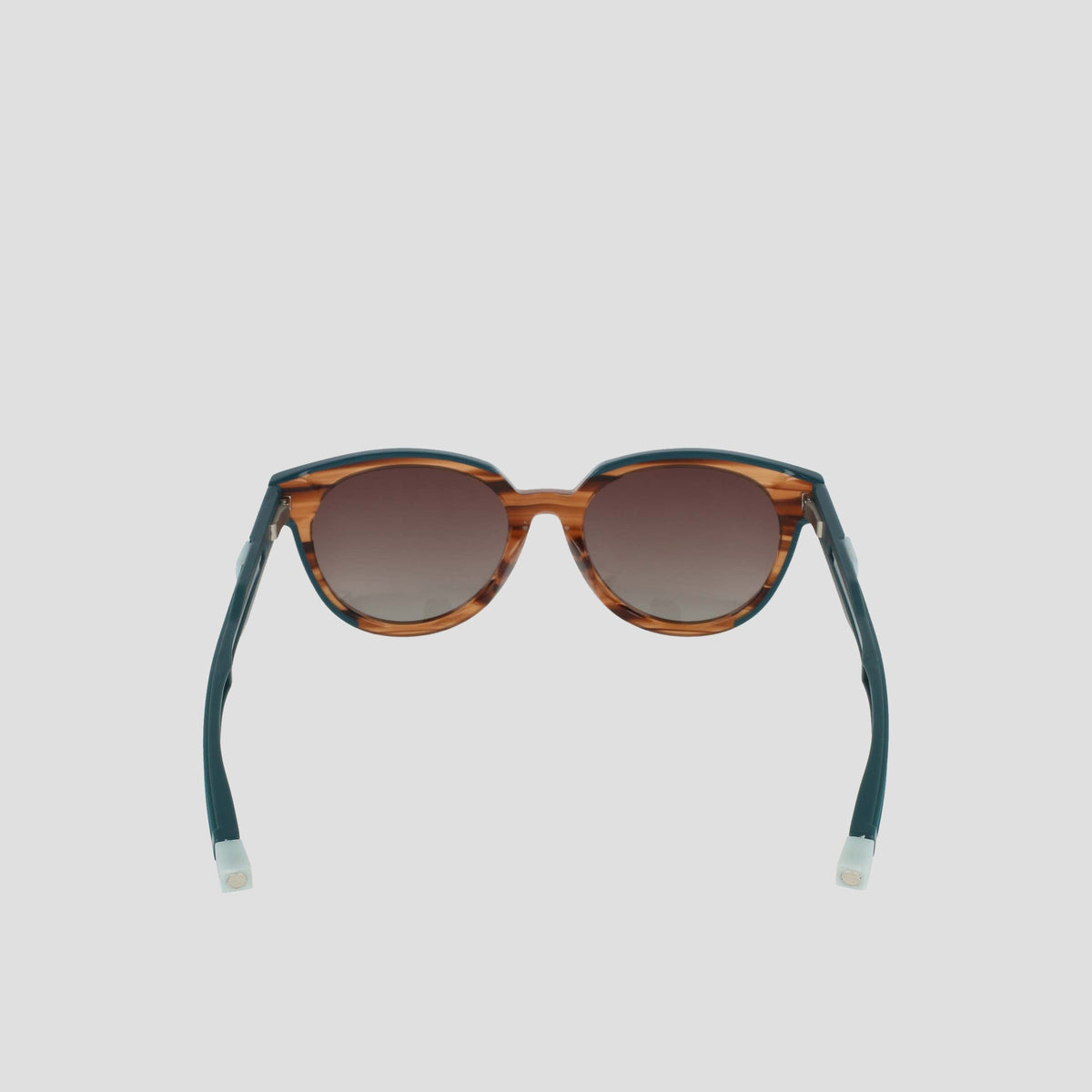 Champion Women's Polarized Retainer Round sunglasses feature brown tortoiseshell round frames, dark gradient polarized lenses, and teal-blue arms with white tips, shown against a light gray background.