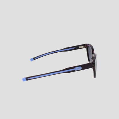 Side view of Champion Women's Polarized Retainer Round sunglasses featuring dark frames with light blue accents on the temple tips and arms, perfect for elevating women’s fashion eyewear against a plain light background.