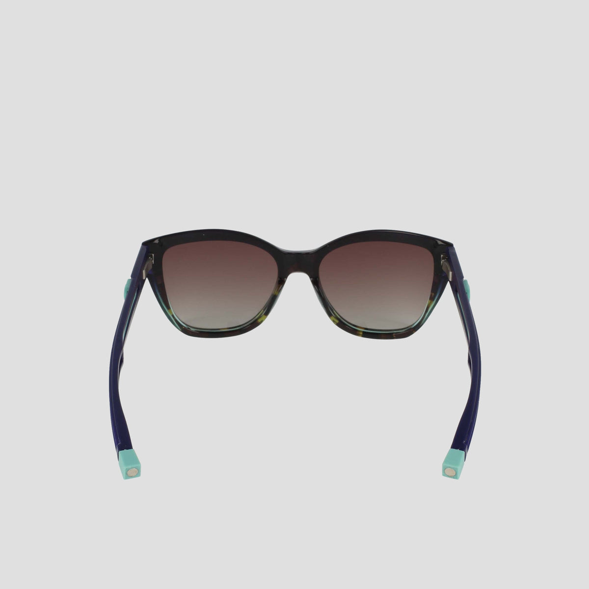 The Champion Women's Polarized Retainer Square sunglasses feature dark gradient lenses, black handmade acetate frames, and navy blue arms with light blue tips, shown from the back on a plain white background.