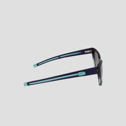 Side view of Champion Women's Polarized Retainer Square sunglasses, featuring dark handmade acetate frames, polarized lenses, and light blue accents on the arms and tips, set against a plain light background.