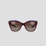 Front view of Champion Women's Polarized Retainer Square sunglasses featuring a bold square frame in dark purple and burgundy handmade acetate with brown gradient lenses, set against a plain light gray background.