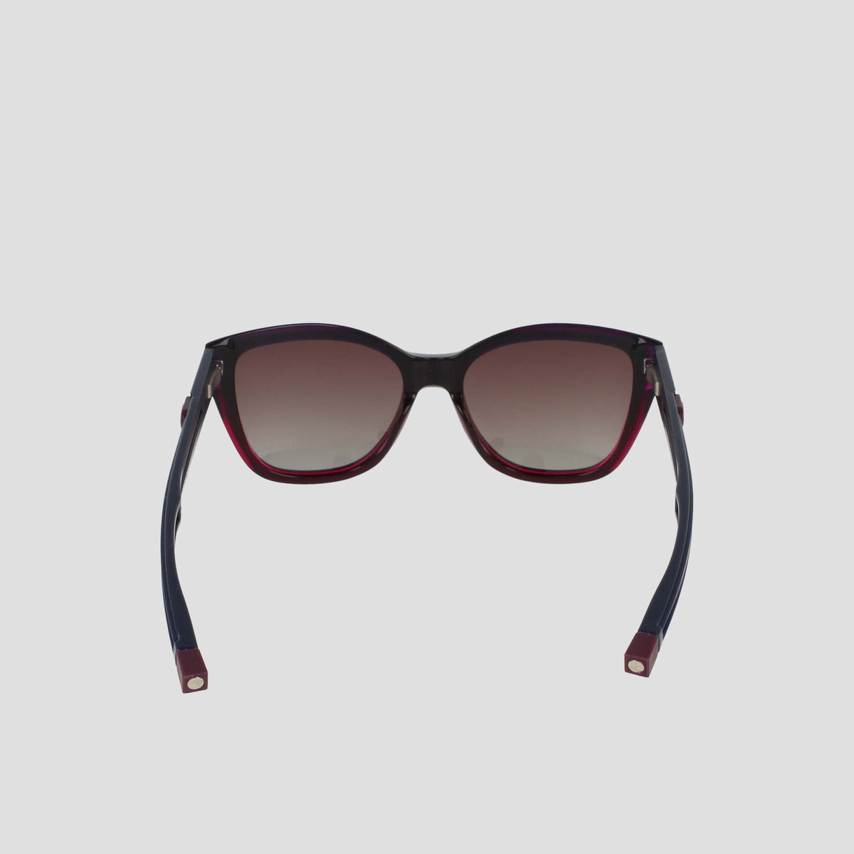 The Champion Women's Polarized Retainer Square features bold cateye sunglasses with dark gradient polarized lenses, black handmade acetate frames, and red accents on the arms and lower rims, displayed front-facing against a plain light background.