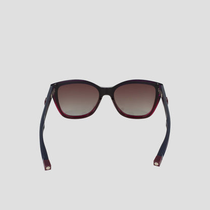 The Champion Women's Polarized Retainer Square features bold cateye sunglasses with dark gradient polarized lenses, black handmade acetate frames, and red accents on the arms and lower rims, displayed front-facing against a plain light background.