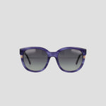 The Champion Women's Polarized Curvaceous Square sunglasses are shown from the front against a plain light gray background. These oversized purple sunglasses feature gradient dark lenses, a glossy acetate frame with subtle gold accents on the sides near the hinges, and an RX-able design for customized prescription lenses.