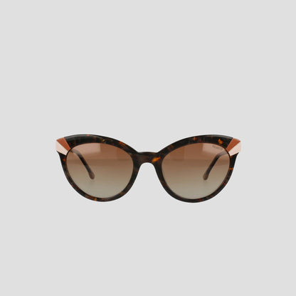 Champion Women's Polarized Cateye sunglasses with a tortoiseshell cat-eye frame, gold accents on the upper corners, and gradient brown polarized lenses featuring RX-able frames, displayed against a plain light gray background.