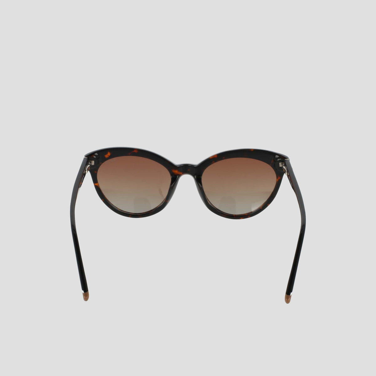 The Champion Women's Polarized Cateye sunglasses, featuring a brown tortoiseshell cat-eye frame and gradient brown polarized lenses, are displayed against a plain light gray background, facing forward with the arms slightly angled outward.