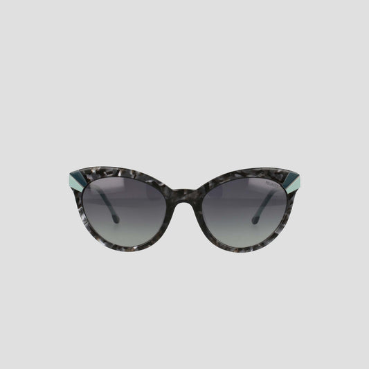 Champion’s Women's Polarized Cateye sunglasses feature black and gray marbled frames, dark gradient lenses, and distinctive teal accents at the upper outer corners. Displayed against a simple light background, these chic cat-eye sunglasses not only offer practical sun protection with their polarized gradient lenses but also elevate your style.