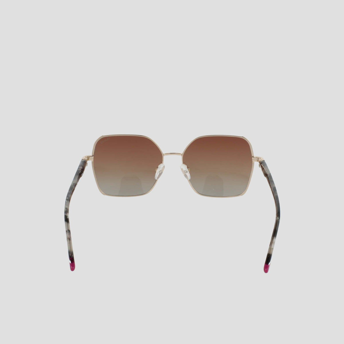 The Champion Women's Polarized Boho Square sunglasses feature a bold square silhouette with gold frames, brown gradient lenses, and thin arms adorned with a marbled pattern and finished with pink tips, showcased against a plain light background.