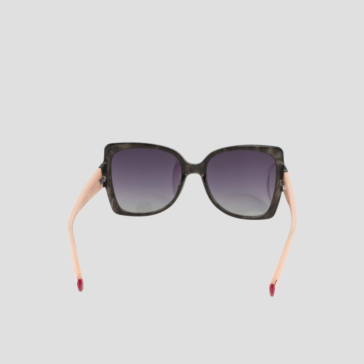 Champion Women's Polarized Oversized Butterfly sunglasses, crafted from handmade acetate, feature a square black front with gradient dark lenses and light pink arms—epitomizing minimalist eyewear. Displayed from the front against a plain light gray background.