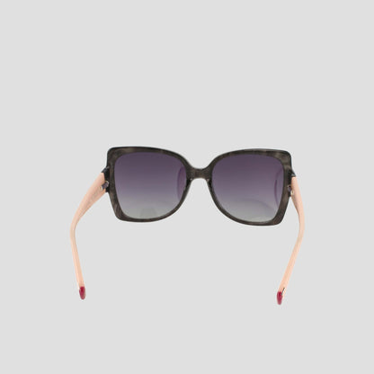 Champion Women's Polarized Oversized Butterfly sunglasses, crafted from handmade acetate, feature a square black front with gradient dark lenses and light pink arms—epitomizing minimalist eyewear. Displayed from the front against a plain light gray background.
