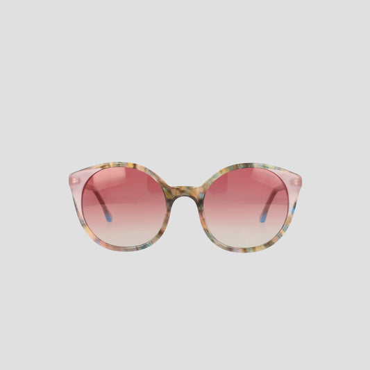 The Champion Women's Polarized Flirty Round sunglasses, featuring a multicolored acetate frame and pink gradient lenses, are displayed against a plain light gray background.