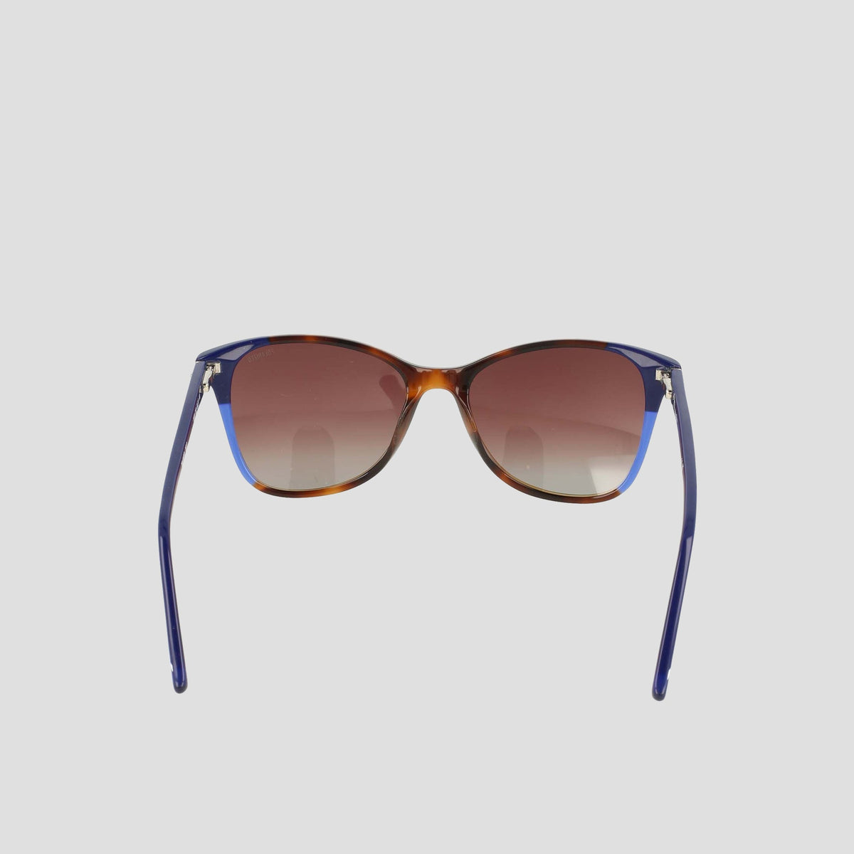A pair of Women's Polarized Catty Square sunglasses by Champion, featuring gradient brown polarized lenses and blue, RX-able frames crafted from handmade acetate eyeglasses material for enhanced durability and comfort. The stylish design is shown from the front against a plain light background.