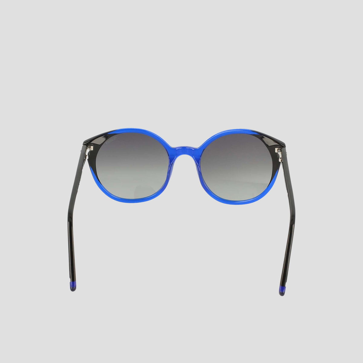 The Women's Polarized Flirty Round sunglasses by Champion feature a bright blue handmade acetate frame and dark gradient lenses, displayed against a plain light gray background.