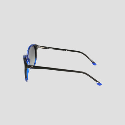 Side view of Champion Women's Polarized Flirty Round sunglasses in black, featuring blue accents on the frames and temple tips, handcrafted from premium handmade acetate with polarized lenses, set against a plain light gray background.
