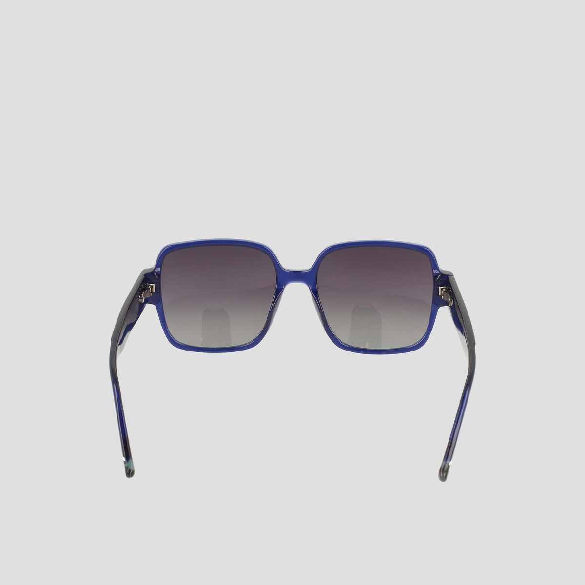 The Champion Women's Polarized Glam Square sunglasses feature blue oversized square frames, dark gradient polarized lenses, and thin black acetate arms, shown facing forward on a plain light background.