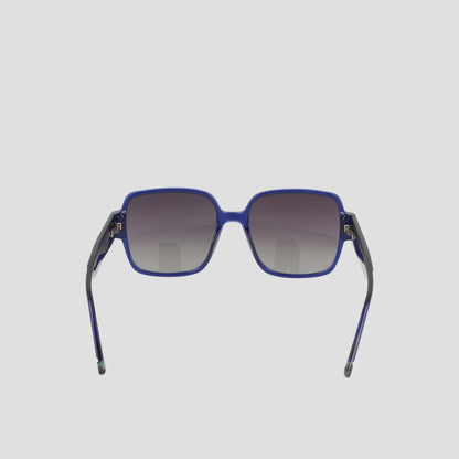 The Champion Women's Polarized Glam Square sunglasses feature blue oversized square frames, dark gradient polarized lenses, and thin black acetate arms, shown facing forward on a plain light background.