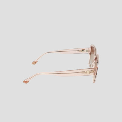 Side view of Champion Women's Polarized Glam Square eyeglasses in translucent pink with thick arms and an oversized square handmade acetate frame, displayed against a plain light gray background.