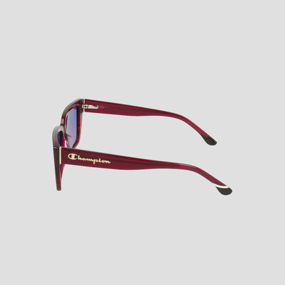 Side view of Women's Polarized Slim Rectangle glasses by Champion in red handmade acetate, thick frames, black-tipped arms, and gold Champion logo, set against a plain light gray background.