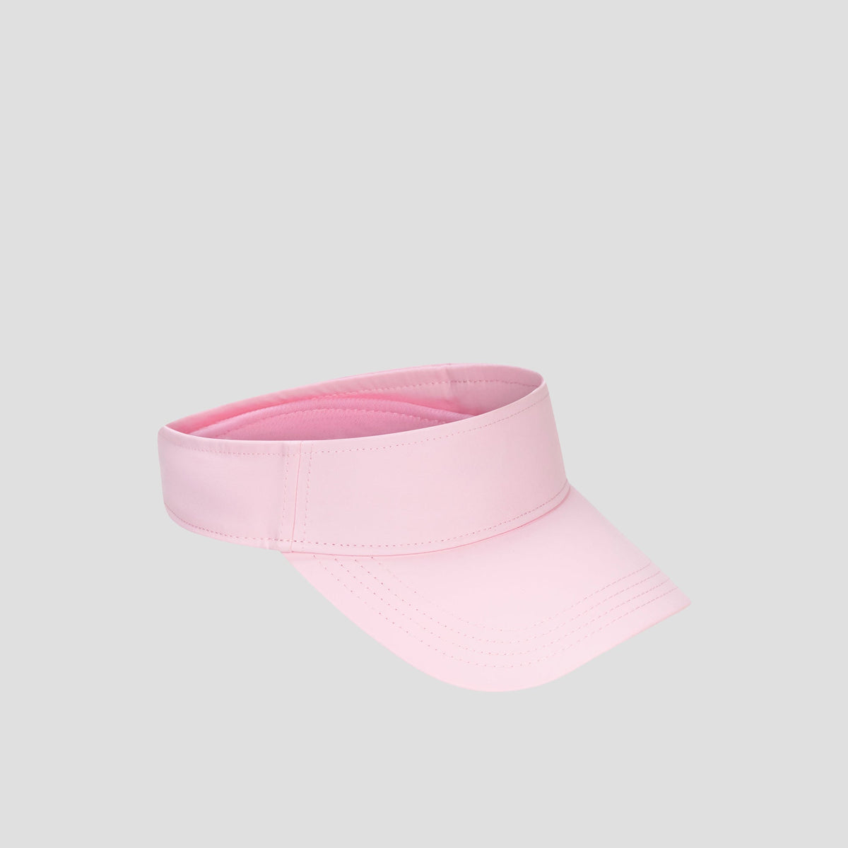 The Champion Adjustable Visor in plain pink is showcased against a light gray background, featuring an adjustable fit and dependable sun protection for active days.