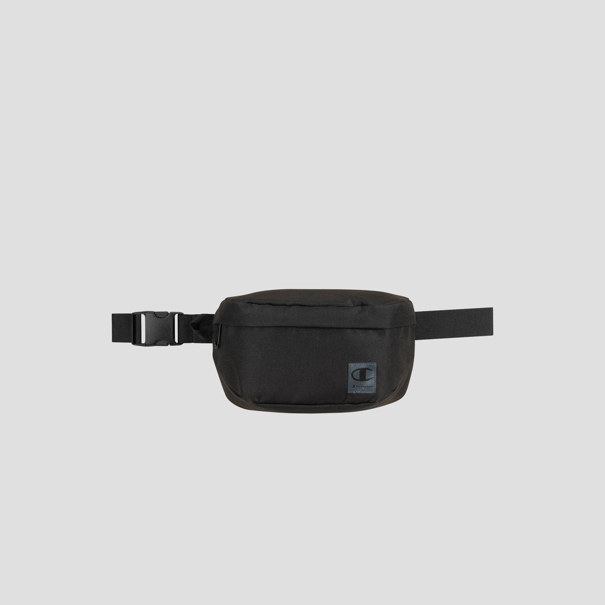 The Champion Atlas Waist Pack, shown against a plain gray background, features a rectangular front pouch, an adjustable strap with a side buckle, and provides adventure-ready storage.