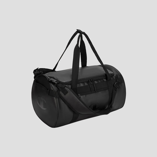Introducing the Champion Approach Convertible Duffel—a versatile black weekend bag featuring two handles, an adjustable shoulder strap, and a front zippered pocket, displayed against a plain light gray background.