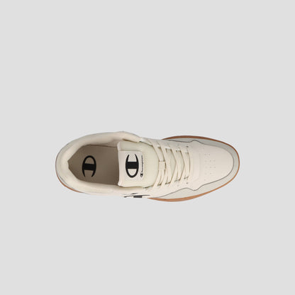 Top view of the Champion Men's Arena Lo V2 T, a cream court sneaker with laces, rubber sole, and black logo detailing on tongue and heel, shown on a light gray background. Heritage styling gives it timeless appeal.