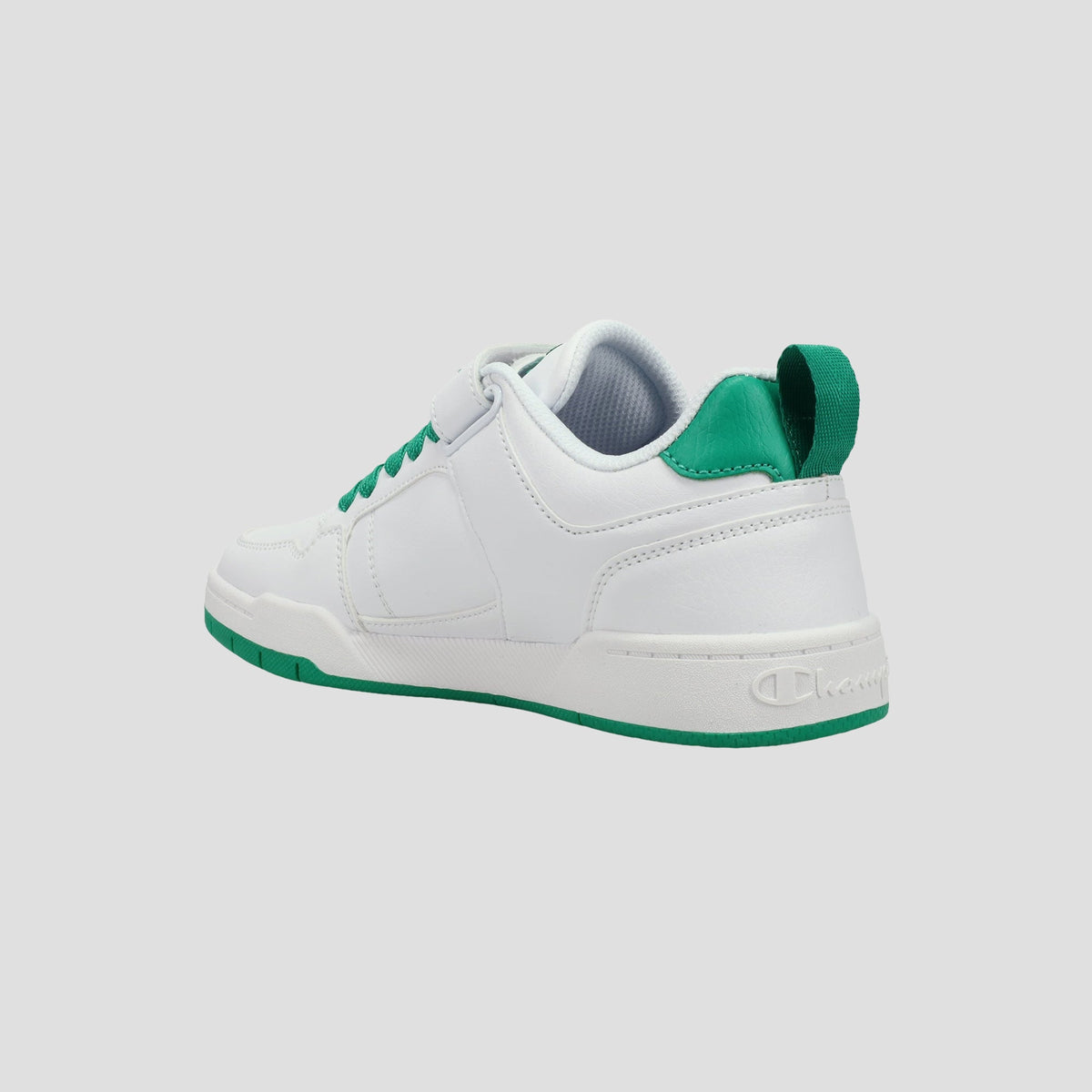 Kids' Arena Power Low sneakers by Champion for kids, shown from a rear-side angle with green accents on the heel, sole, and laces against a plain light gray background—a fresh style for every young trendsetter.