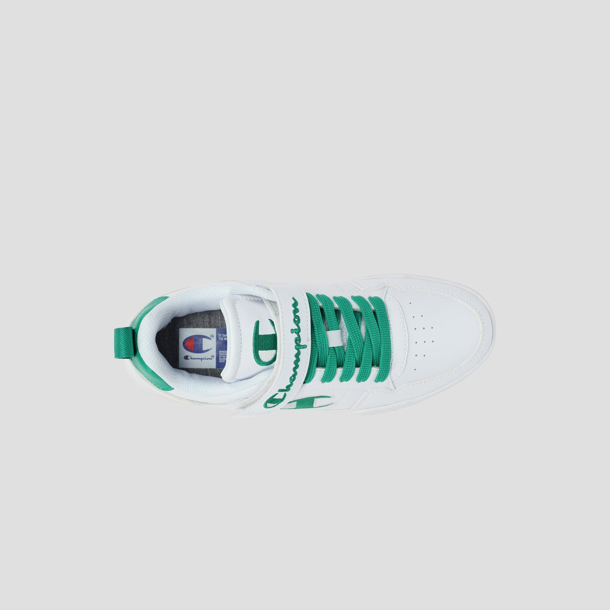 Top view of the white Kids' Arena Power Low by Champion, featuring green laces, lining, and accents on a light gray background. The Champion logo appears on the tongue and side—perfect sporty style for kids' sneakers.