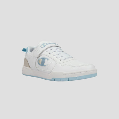 The Champion Kids' Arena Power Low sneaker features a white low-top design with light blue accents, a beige heel tab, the Champion logo on the side, white laces, and a light blue sole. Perfect for classic style on a light gray background.