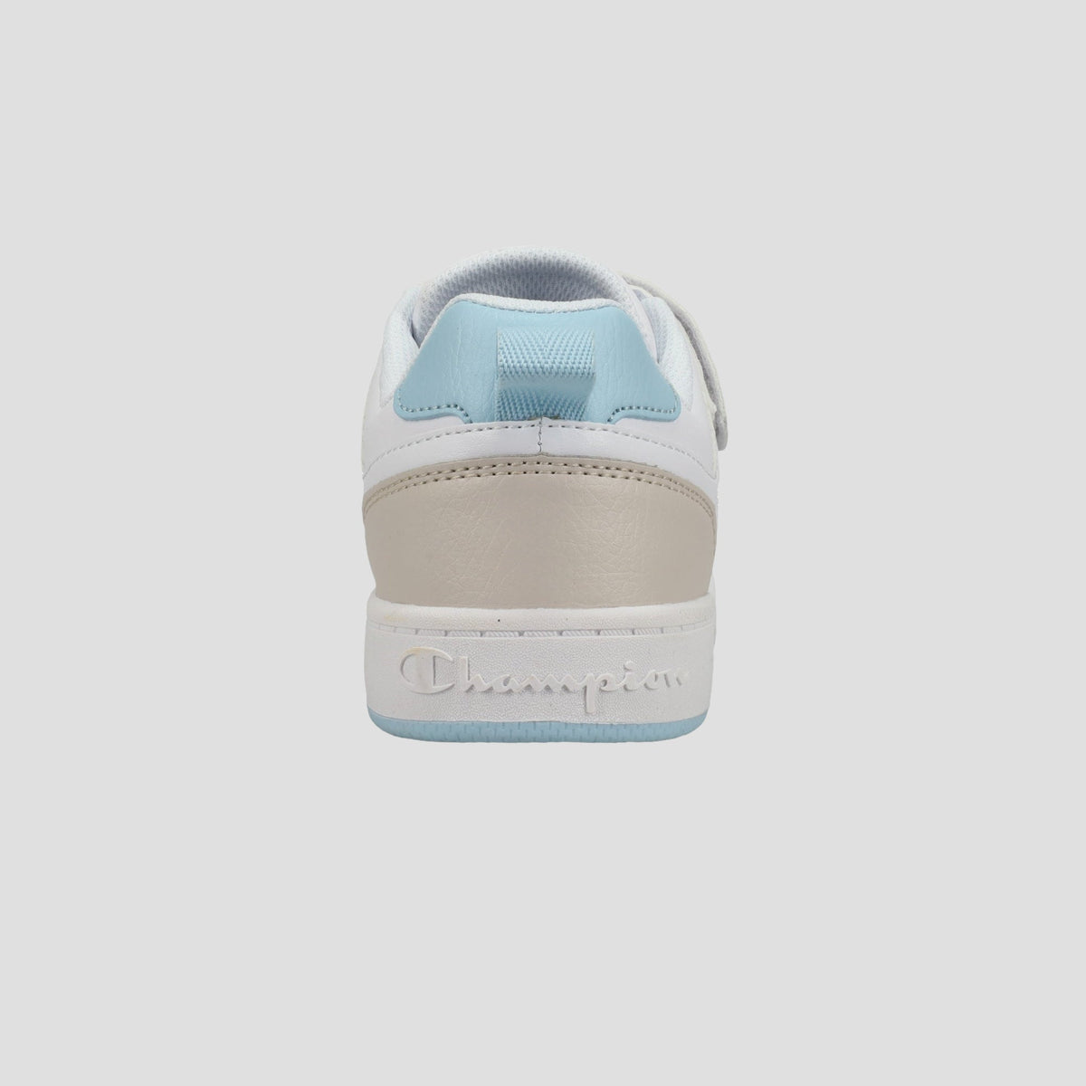 The Champion Kids' Arena Power Low sneaker is shown from the back, with a white upper, light blue heel tab and sole, beige heel accent, and "Champion" embossed on the midsole for signature style.