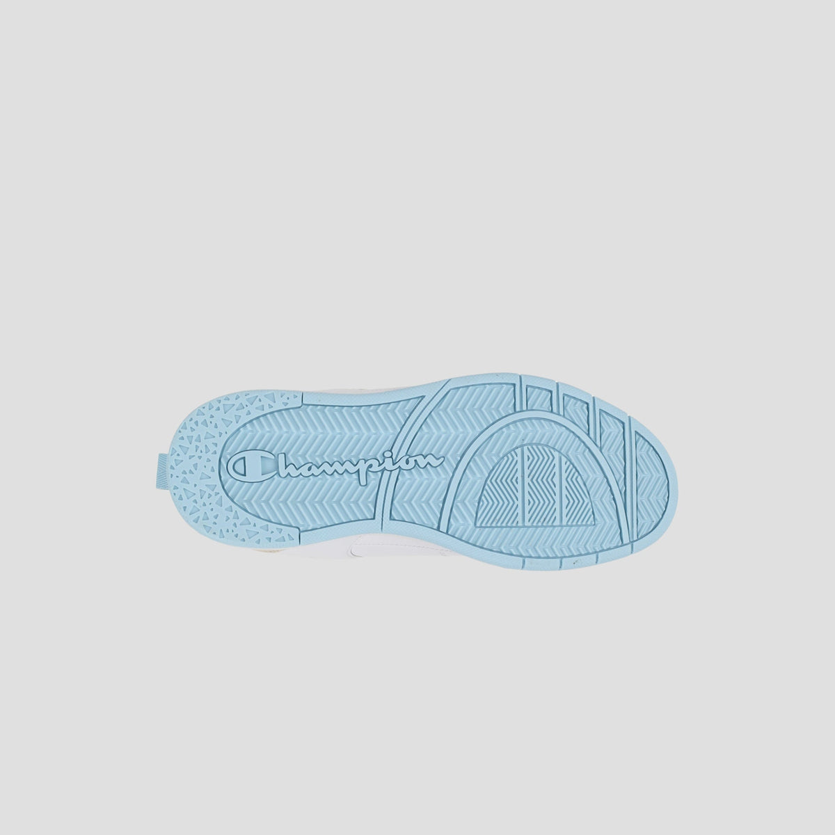 The image shows the light blue sole of the Champion Kids' Arena Power Low sneaker with "champion" embossed in the center and various textured grip patterns.