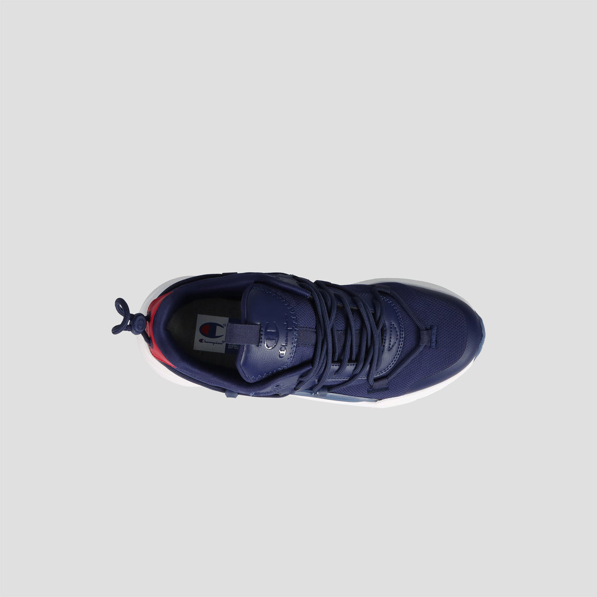 Top view of the Champion Men's Hyper C Pilot sneaker in navy blue, featuring a durable mesh upper, black laces, white sole, heel pull tab, logo on the tongue, and red detail at the back. Set against a light gray background.