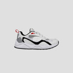 The Champion Men's 9318 Vale is a white athletic sneaker with black and gray accents, a cushioned collar, durable rubber sole, and red heel pull tab, displayed in side profile against a plain light gray background.