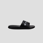 The Champion Kids' Mega SFB Slide is a black sandal with a thick strap, white logo and design, shown from the side on a light gray background. It features a contoured footbed for lightweight comfort.