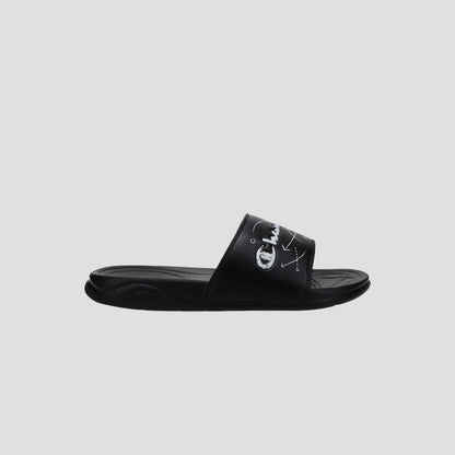 The Champion Kids' Mega SFB Slide is a black sandal with a thick strap, white logo and design, shown from the side on a light gray background. It features a contoured footbed for lightweight comfort.